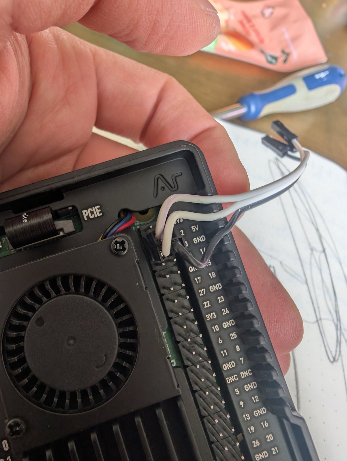 Three jumper wires connected to the SDA, SCL and GND pins of the Raspberry Pi 5 GPIO header, with the UPS power pins left dangling unconnected